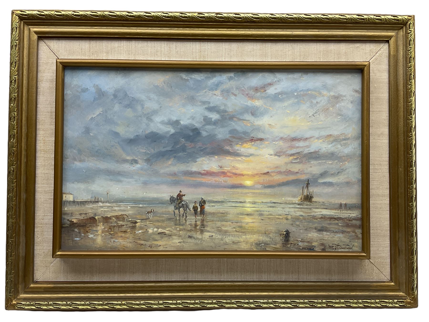 John Lewis Chapman (British 1946-): A Sunset Ride on the Beach, oil on board signed 24cm x 40cm