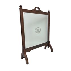 Late 19th century mahogany and glass fire screen, moulded frame enclosing glass panel with central Camel scene within desert landscape decorated with pyramids and trees, foliage carved handles with central ring turning, on splayed moulded supports