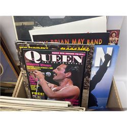 Mostly Queen and Freddie Mercury interest items, including pin badges, newspaper cuttings, diecast 'promotional' vehicles, special edition Pop Rocks figure of Freddie Mercury, VHS tapes, two charity certificates signed by Brian May and Roger Taylor, poster etc, in two boxes 
