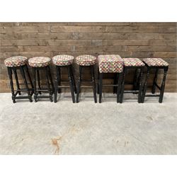 Seven tall bar stools with upholstered seat