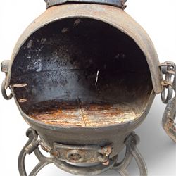 Cast iron garden chiminea, with mesh front spark guard, flue chimney on three splayed legs, finished in black.