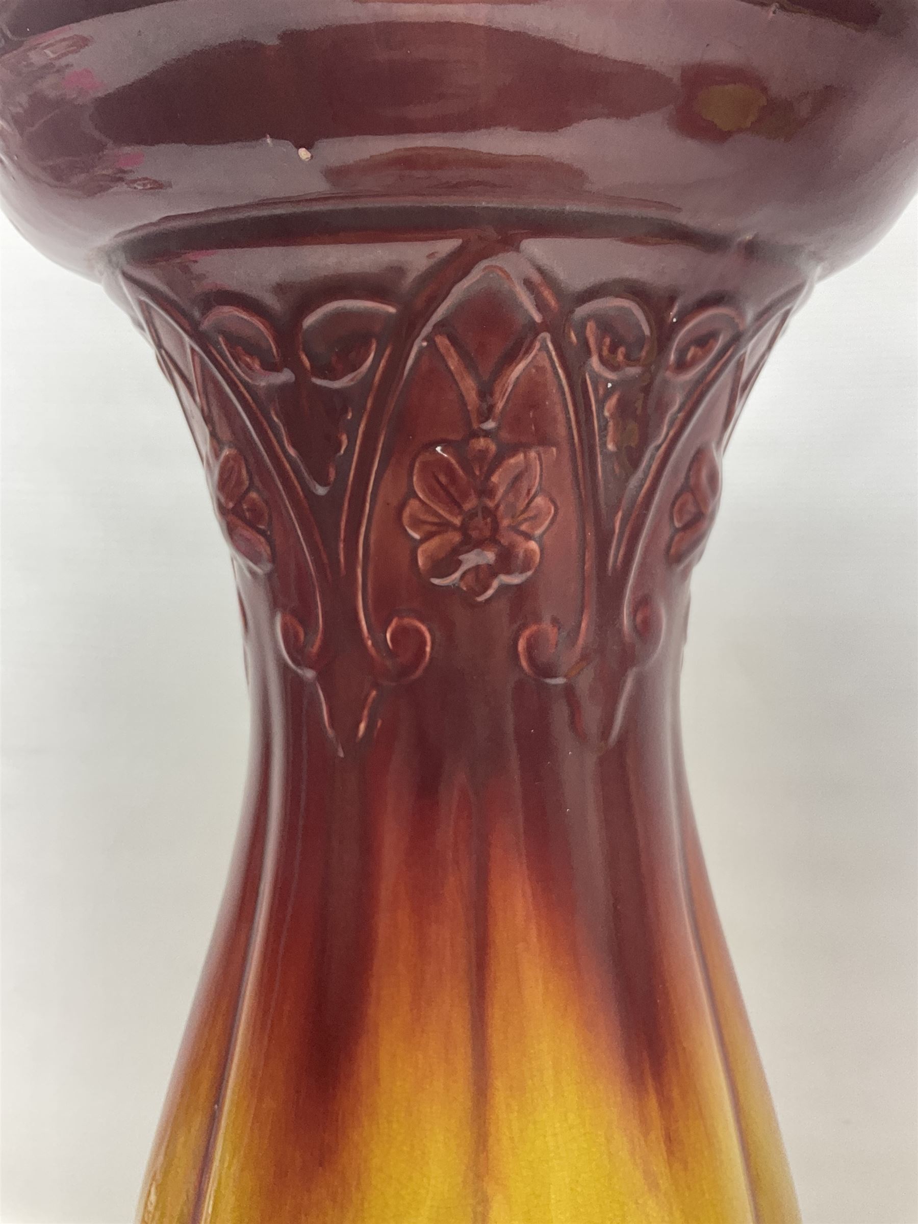 Bretby Jardiniere and stand, with foliate and foliage decoration with a red and yellow ground, impressed mark beneath H94cm