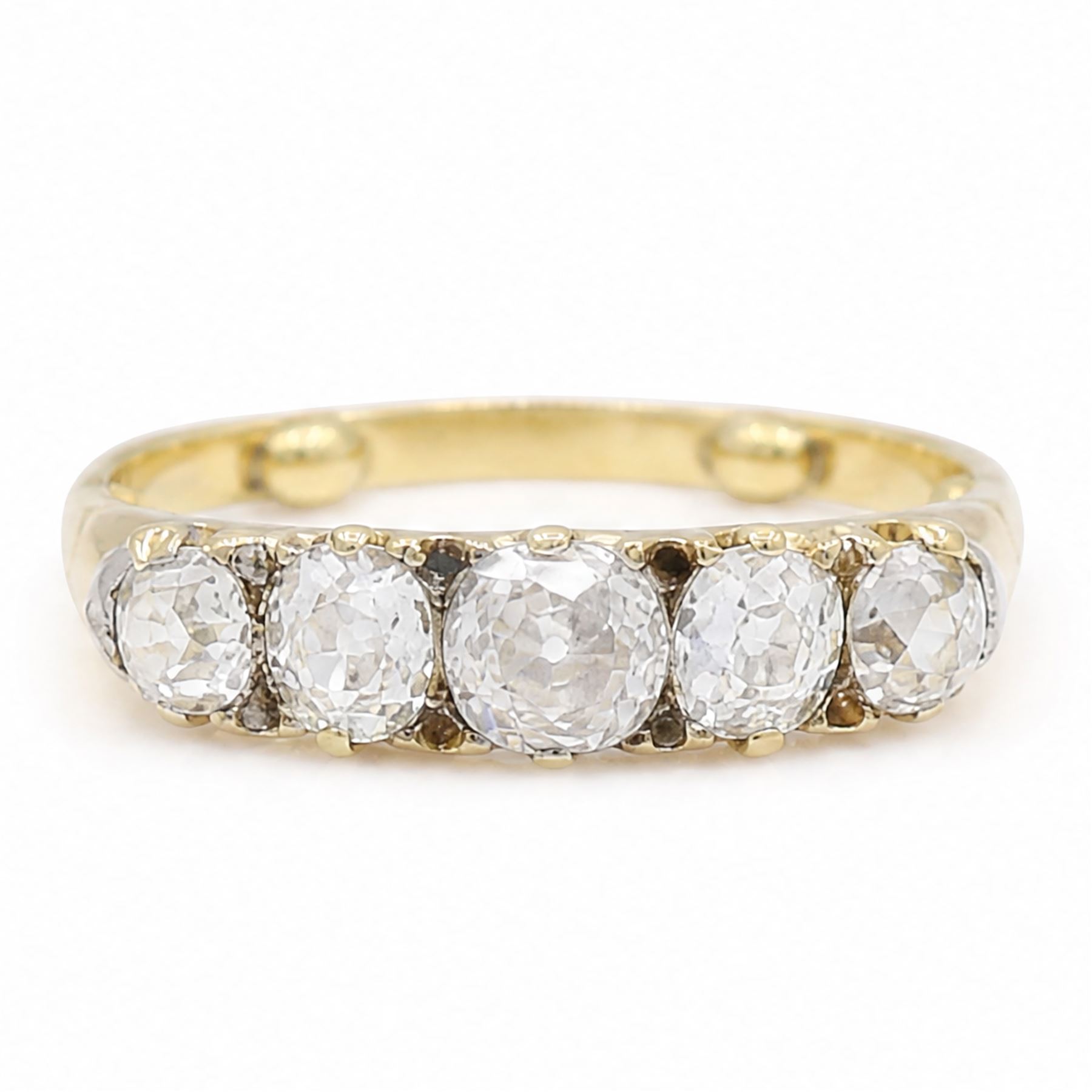 Early 20th century 18ct gold diamond ring, set with five graduating old cut diamonds and diamond accents, total diamond weight approx 1.55 carat