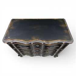 French style black lacquered chest of drawers, the serpentine front fitted with three graduated drawers mounted with scrolling foliate metal handles and key plates, shaped apron and scrolled cabriole legs