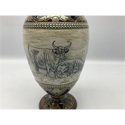 Late 19th century Doulton Lambeth sgraffito vase decorated by Hannah Barlow, of ovoid form with waisted neck and flared rim, upon a circular spreading foot, decorated with a central sgraffito band of grazing cattle between shell and foliate detailed borders, with impressed and incised marks beneath including monogram, H28cm