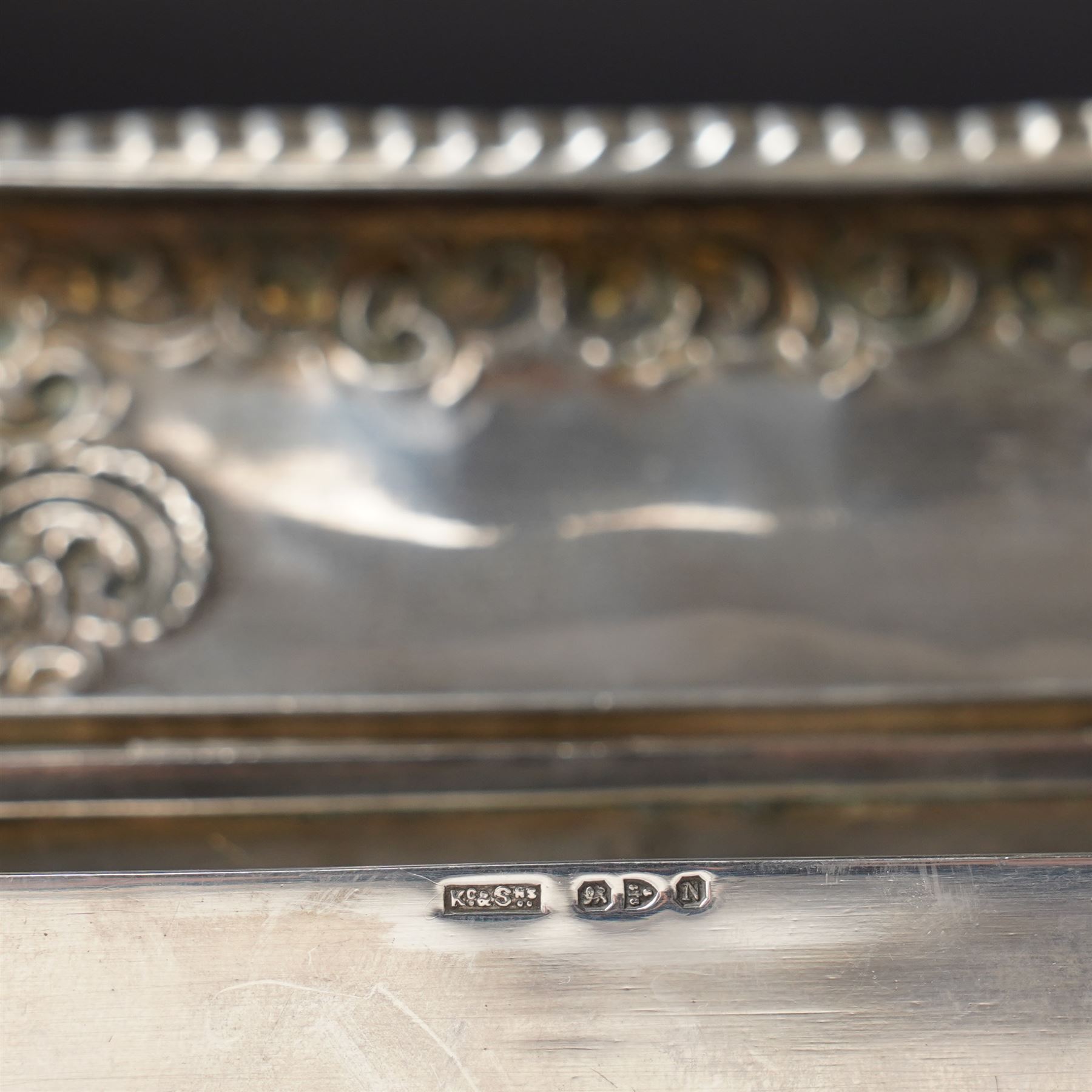 Late Victorian silver dressing table box of rectangular form with embossed hinged lid and engraved with a monogram with crimped border W15.5cm Chester 1896 Maker King & Sons