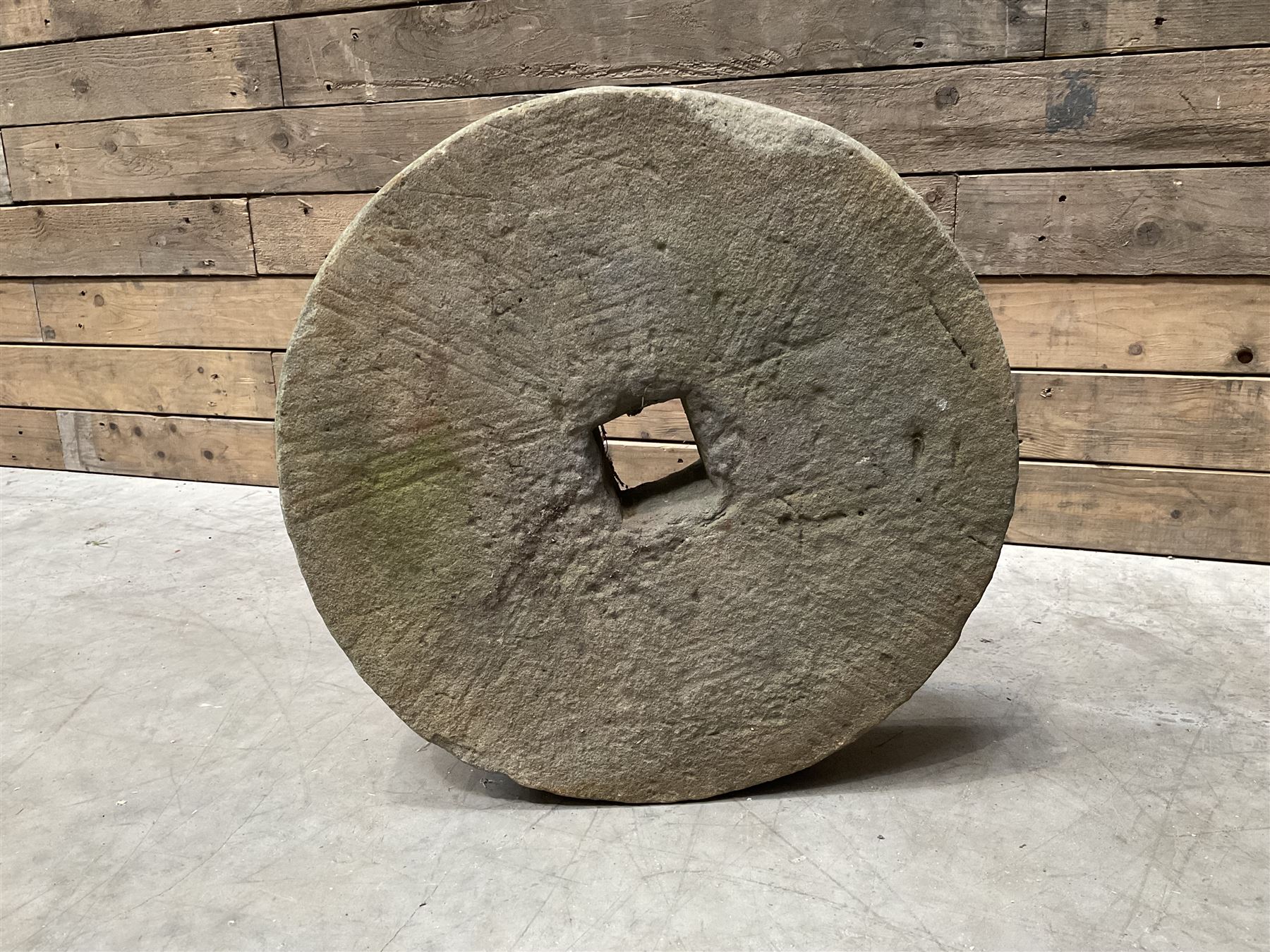 19th century circular stone mill wheel,