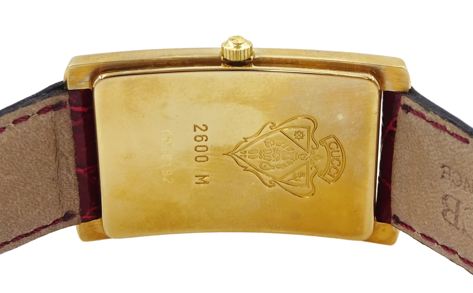 Gucci gold-plated rectangular quartz wristwatch, Ref. 2600M, red and silvered dial, on original red leather strap, boxed