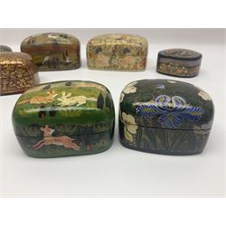 Nine lacquered boxes, all rectangular form, including russian examples decorated with animals within a stylized landscapes and example with flower decoration, largest H7cm, L11cm