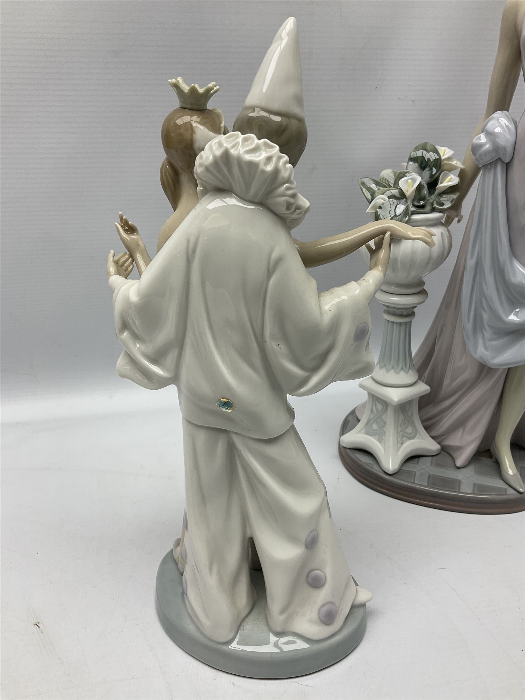 Four Lladro figures, comprising Touch of Class no 5377, Boy Student no 4517, Ocean Beauty no 5785 and Carnival Couple no 4882, largest example H45cm