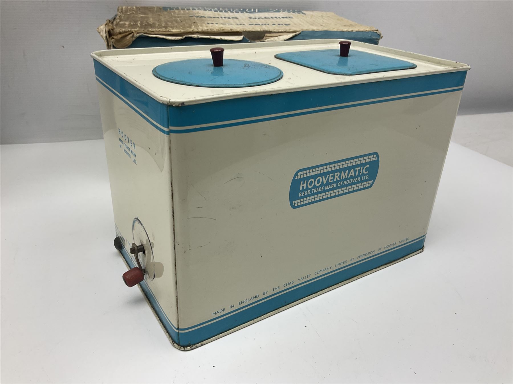 Six toy kitchen appliances - Casdon battery operated cooker; Mettoy Hoover washer; Chad Valley Hoovermatic washer; Wells Brimtoy tin-plate clockwork washer; and two Morphy Richards irons; together with a continental child's Regina sewing machine; all boxed (7)