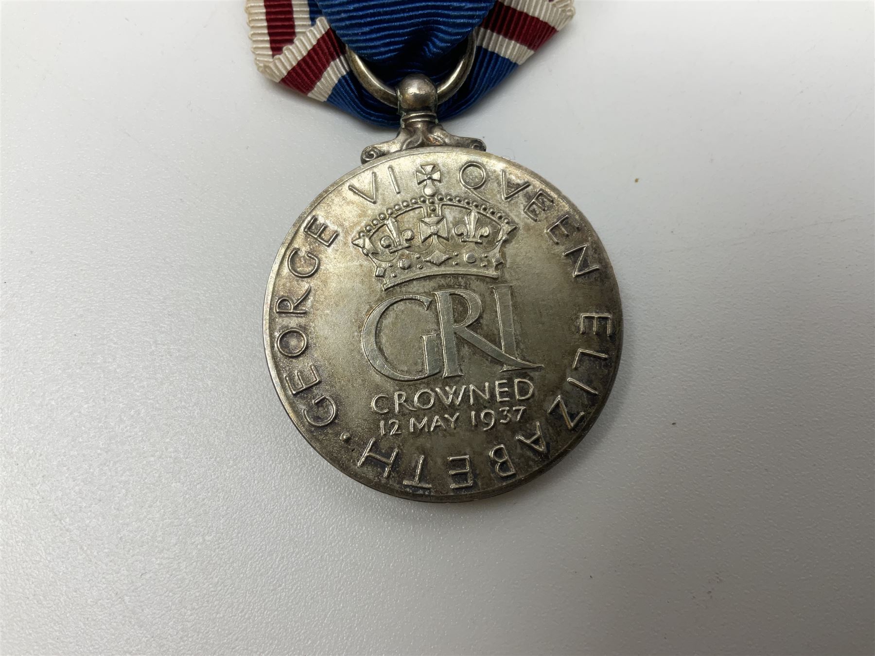 Collection of WW2 and police medals c.1933-1955, awarded to Eric Drinkwater comprising 1939-45 War Medal, Defence Medal, 1939-45 Star and Burma Star, on wearing bar; 1918-62 General Service Medal with Cyprus clasp to P.S. E.G. Drinkwater; boxed; Police Long Service and Good Conduct Medal to Const. Eric C. Drinkwater; cased; Royal Life Saving Society bronze medal to E.C. Drinkwater July 1933; boxed; and George V 1937 coronation medallion; boxed.