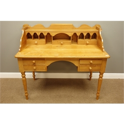  Polished pine kneehole desk, raised shaped back with pigeon holes and drawers, four drawers, turned supports, W134cm, H111cm, D71cm  