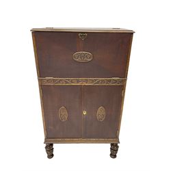 Early 20th century oak cocktail cabinet, fall front with fitted retractable interior, double cupboard below, on acanthus carved baluster feet