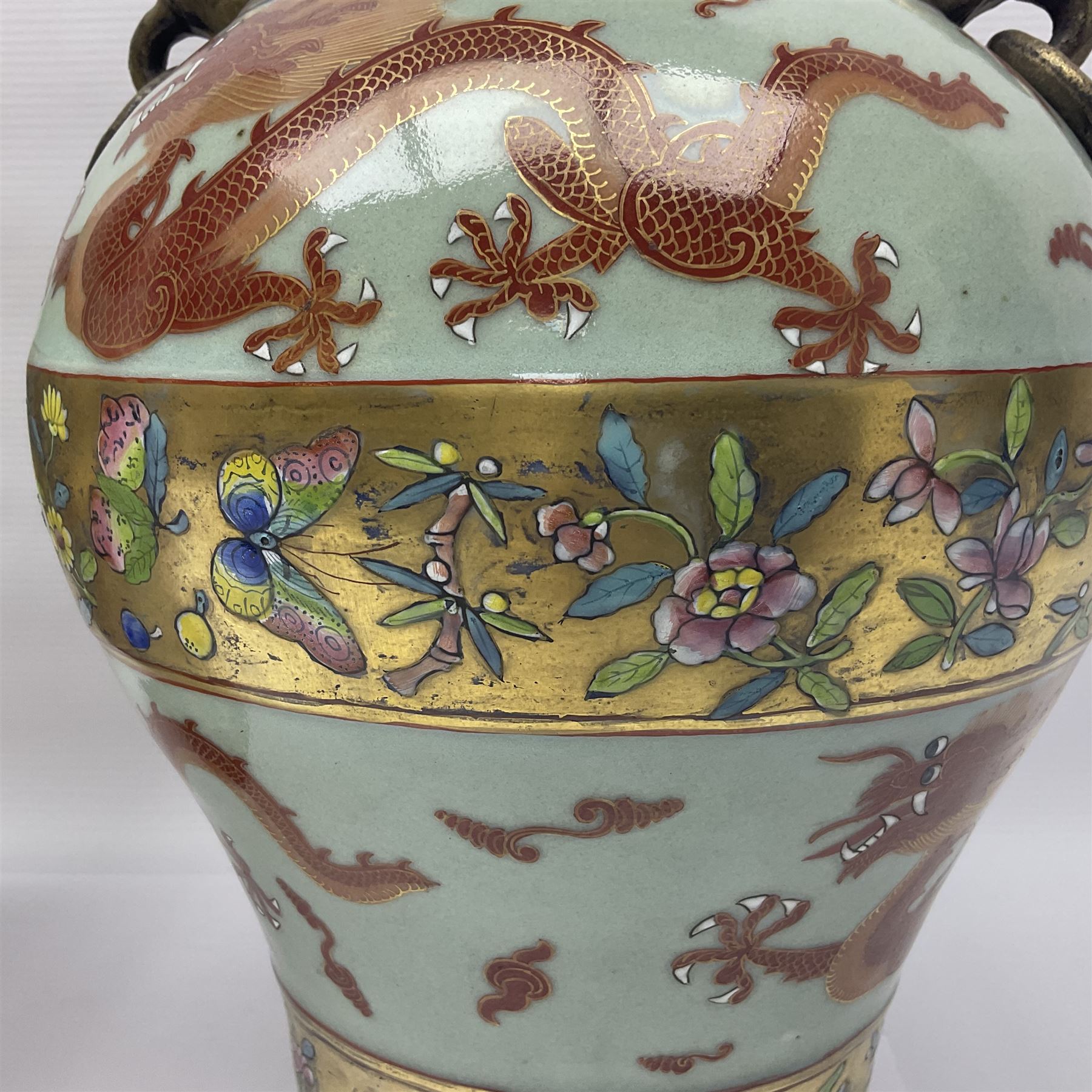 Pair of early 20th century Chinese vases decorated with dragons chasing a flaming pearl, with a gilt border of butterflies and floral sprigs, with Elephant head handles, H44cm 
