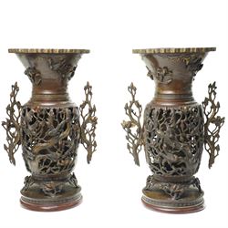Pair of Japanese Meiji period usubata bronze vases, the handles formed as blossoming branc...