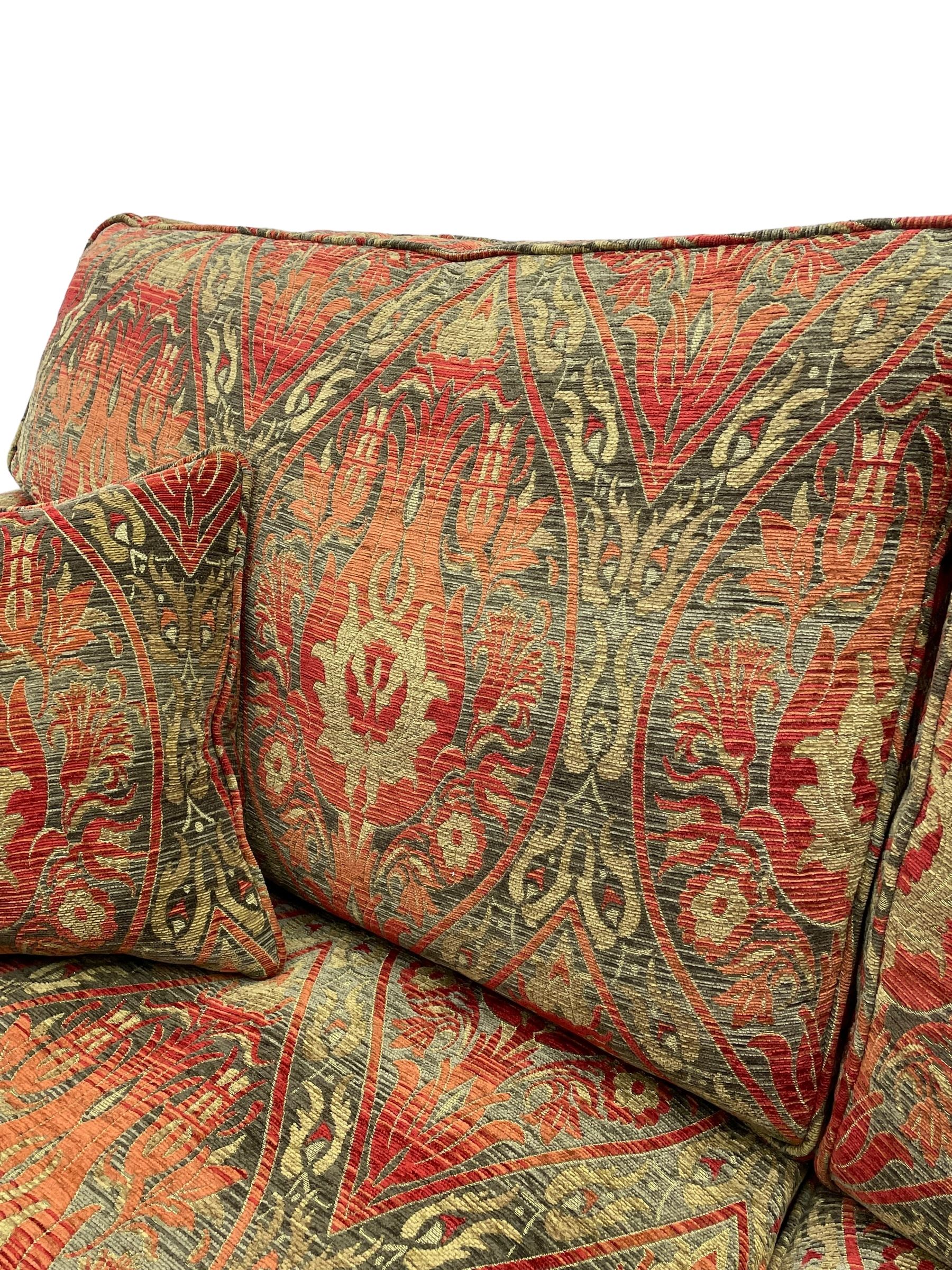 Duresta - 'Beaminster' grande two-seat sofa, traditional shape with rolled arms, upholstered in 'Althorp' russet and stone floral pattern fabric, on turned feet with brass castors
