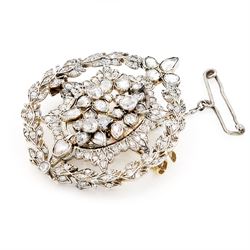 19th century floral spray diamond brooch, three central flower heads set with rose cut and old cut diamonds within an sunburst surround and outer wreath border, set with further rose cut diamonds 