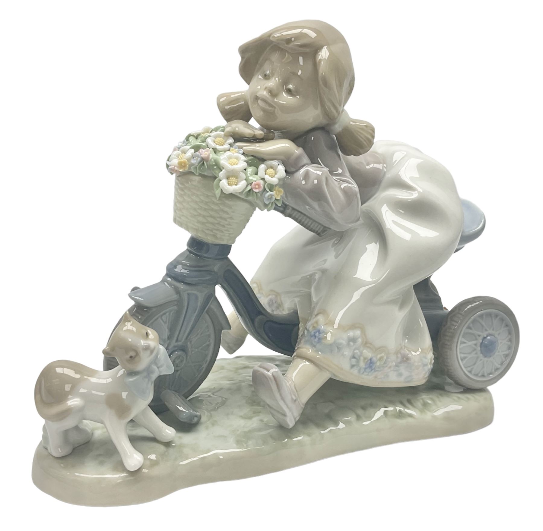 Lladro figure, In No Hurry, modelled as a girl on a tricycle, sculpted by Francisco Polope, with original box, no 5679, year issued 1990, year retired 1994, H15cm