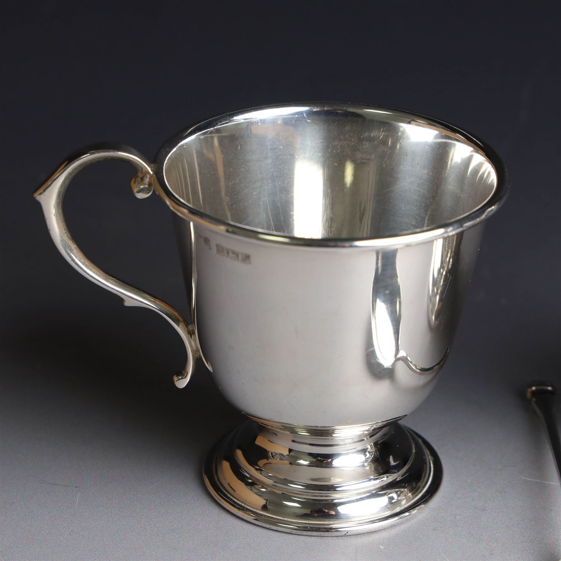 Two late 20th century silver christening mugs, each of plain form with no engraving, together with a small seal top spoon, all hallmarked 