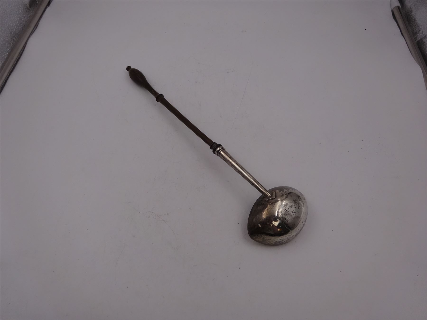 George II silver toddy ladle, the silver bowl of oval form, with engraved initials to underside, hallmarked London 1741, maker's mark indistinct, with turned wooden handle, L33cm