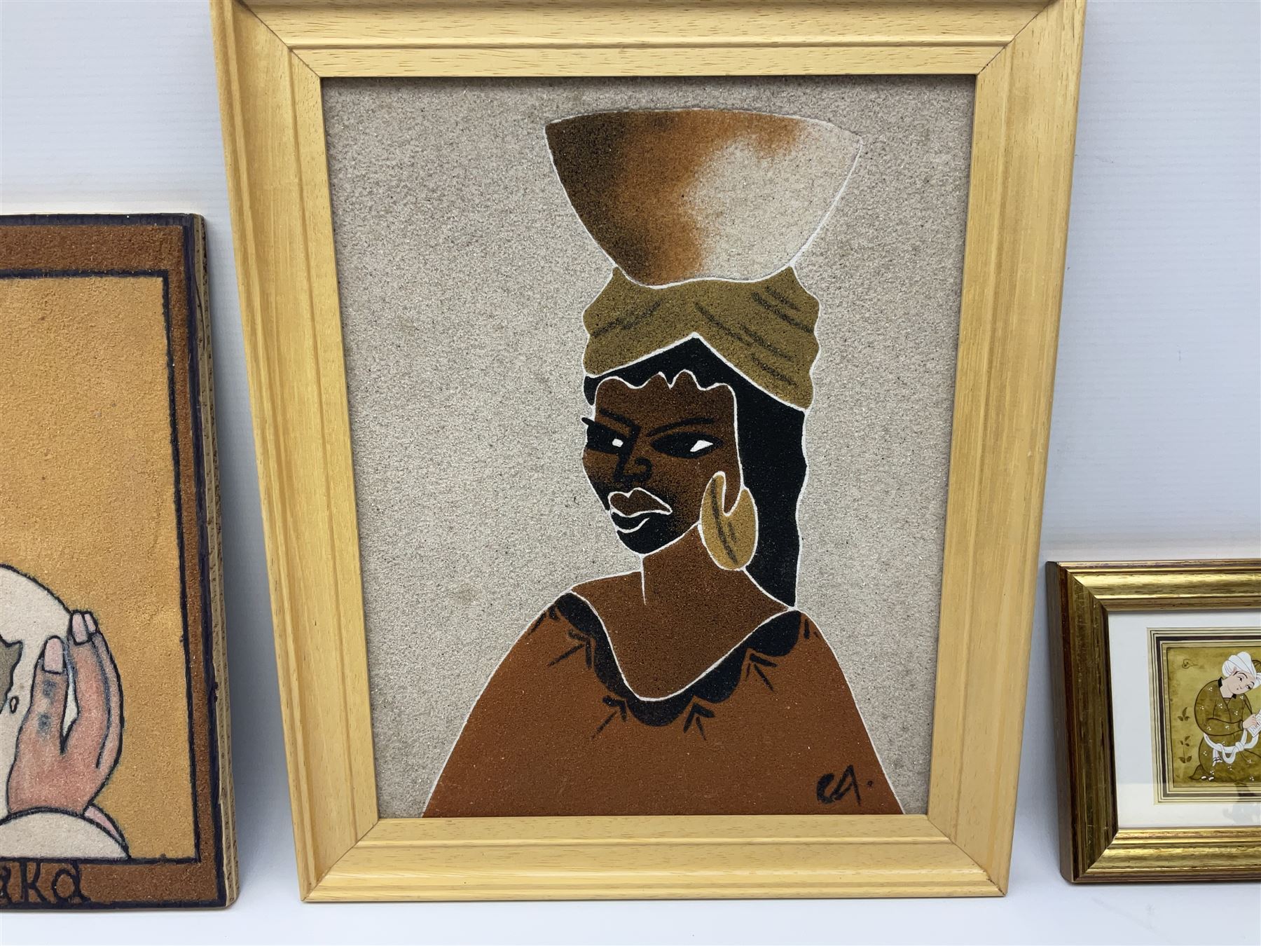 Jasur Orziev (20th century): Couple playing Sitar, miniature gouache signed; African School (20th century): Woman with Bowl on Head, sand on board signed CA together with another sand painting with hands on a globe inscribed Abaraka max 29cm x 23cm (3)