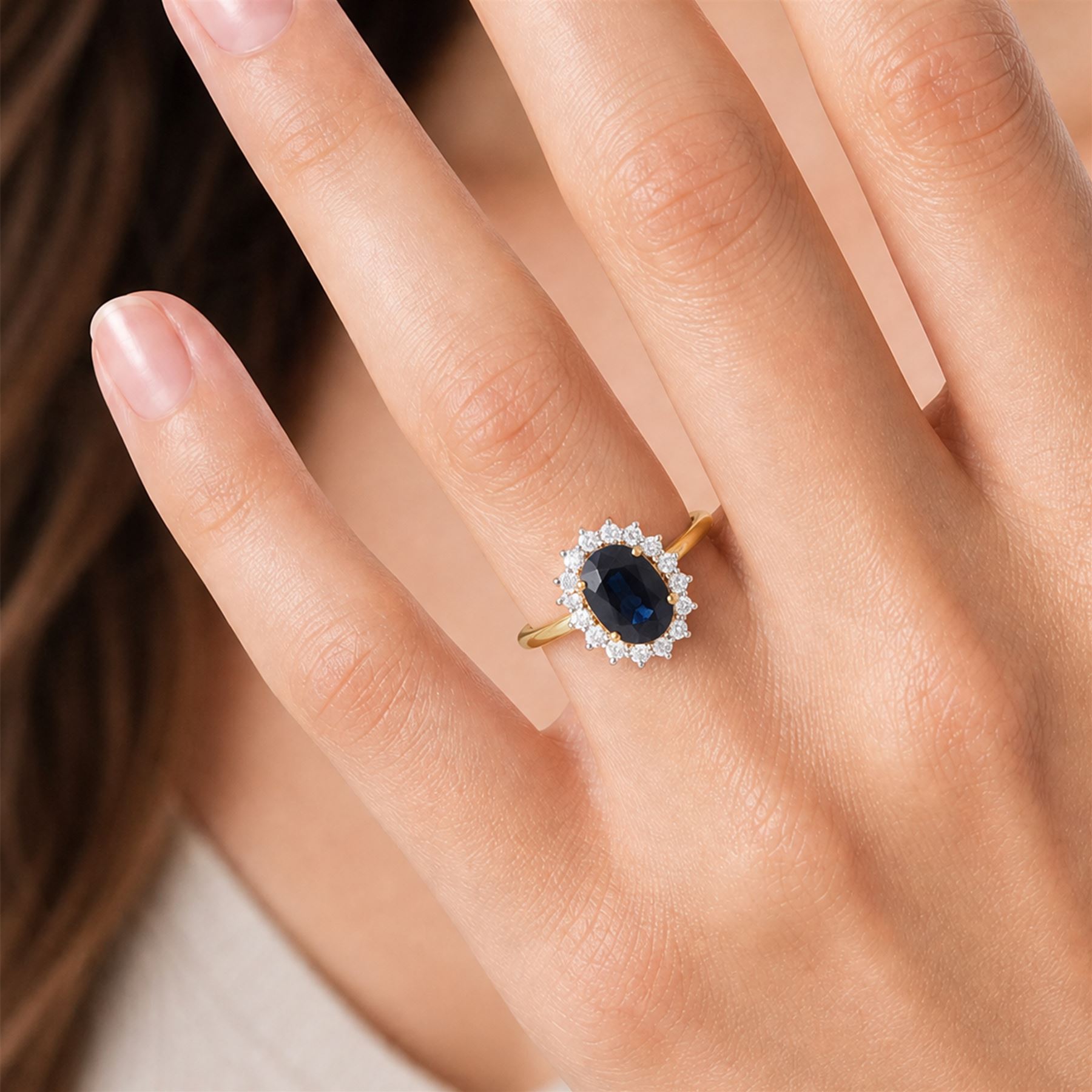 18ct gold sapphire and diamond cluster ring, single oval cut sapphire of approx 2.60 carat, surrounded by sixteen round brilliant cut diamonds, hallmarked, total diamond weight approx 0.45 carat