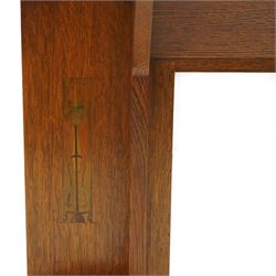 Manner of Liberty & Co, - Arts & Crafts inlaid oak overmantel mirror, the deep-projecting cornice over a rectangular plate, flanked by Art Nouveau marquetry panels of stylised tulip and foliate motifs, over a canted shelf and tulip-pierced upright