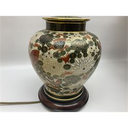 Pair of Japanese ceramic table lamps, decorated with flowers and butterflies upon a circular wooden base, with shades H52cm