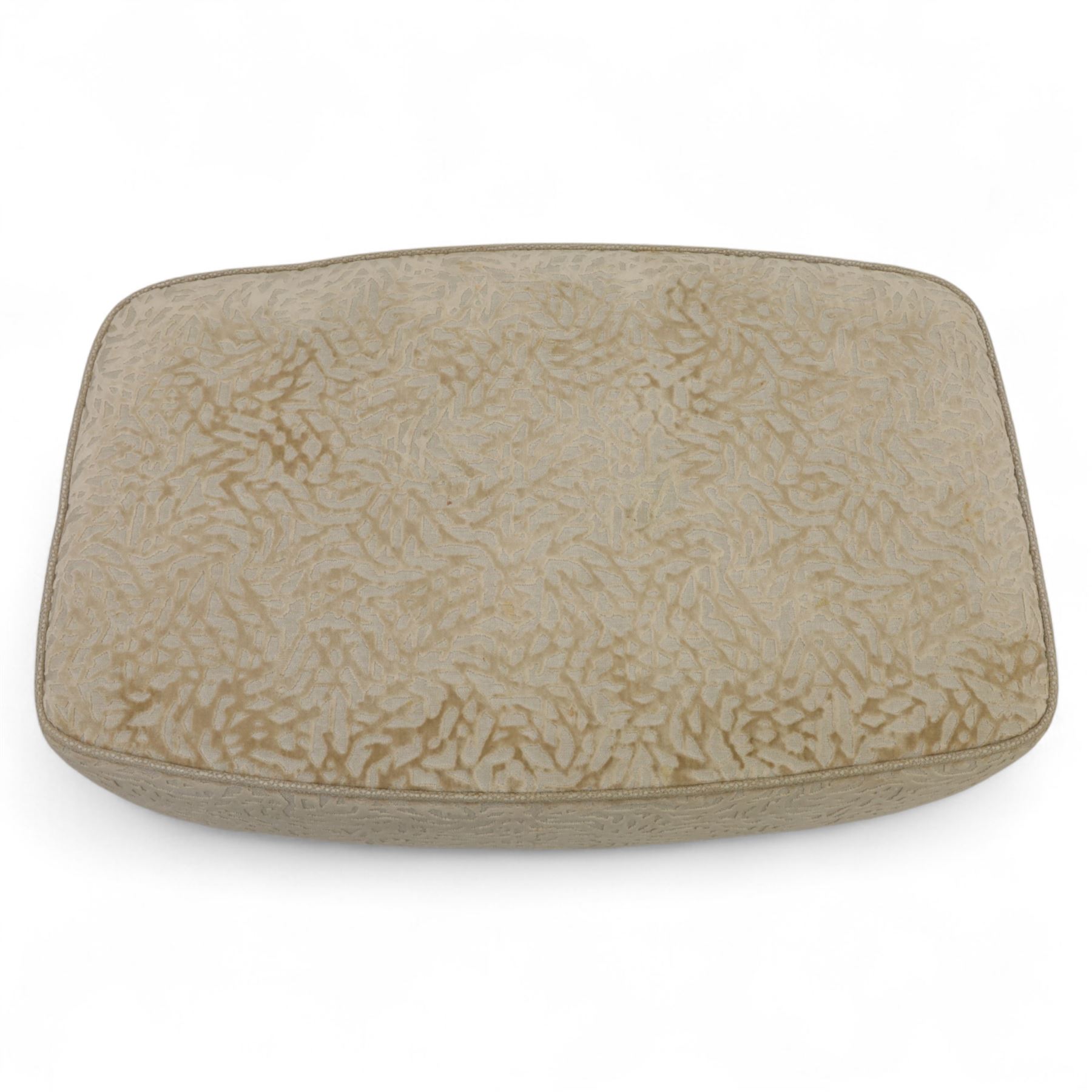 Late 20th century wingback armchair and matching footstool, upholstered in beige embossed fabric with brass stud edging, on cabriole legs and splayed rear legs, together with a matching footstool on turned supports terminating in brass castors (Stool H 42cm, W 75cm, D 47cm)