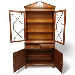 Georgian design Pollard -Oak bookcase cabinet over cupboard with panelled cupboards and two drawers, arched pediment above a dentil frieze and a pair of glazed doors enclosing adjustable shelves, raised on shaped bracket feet