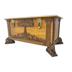 India camphor wood blanket box, moulded hinged lid, decorated with carved elephants and trees, on elephant carved feet