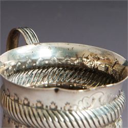 Victorian silver christening mug, of circular form with C scroll handle, embossed with scrolls and foliate decoration, with vacant oval cartouche to body, hallmarked John Aldwinckle & Thomas Slater, London 1890, contained within a tooled leather fitted case, mug H8cm