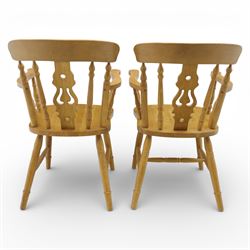 Solid oak dining table and set of seven pine farmhouse chairs including two carvers, rectangular top with tongue and groove style finish, supported a 'H' stretcher with square chamfered legs, pine farmhouse chairs with central splat and turned legs