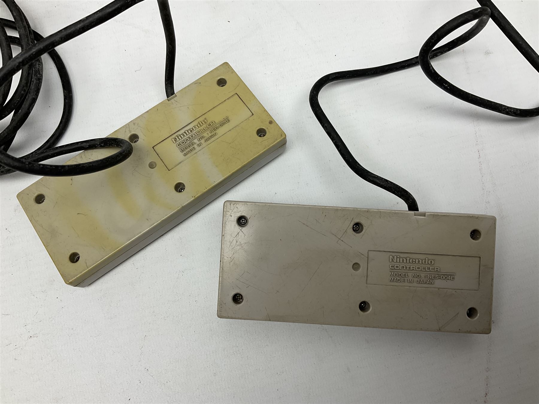 Nintendo Entertainment System (1985) console with two controllers, accessories and instruction booklet. NES Games ‘Duck Hunt’ with Nintendo Zapper gun, ‘Pinball’ and ‘Super Mario Bros.’, all with original sleeves and instruction booklets. NES game ‘Super Mario Bros. 2’ cartridge only