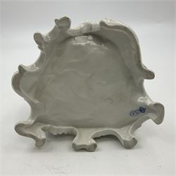 Figure group, probably Volkstedt, modelled as a courting couple seated before a table, the ornate bench and table conforming with and leading from the gilt heightened scrolling base, with blue painted mark beneath, H14.5cm
