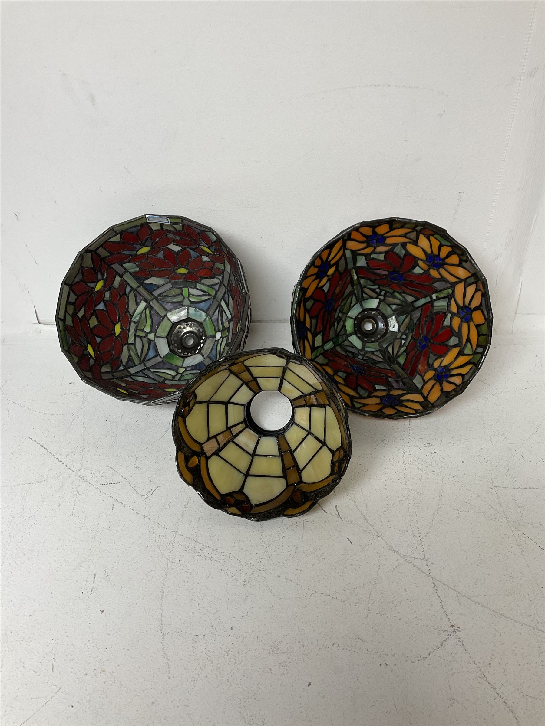 Three Tiffany style lamp shades, each with multicoloured floral decoration, largest D20.5cm