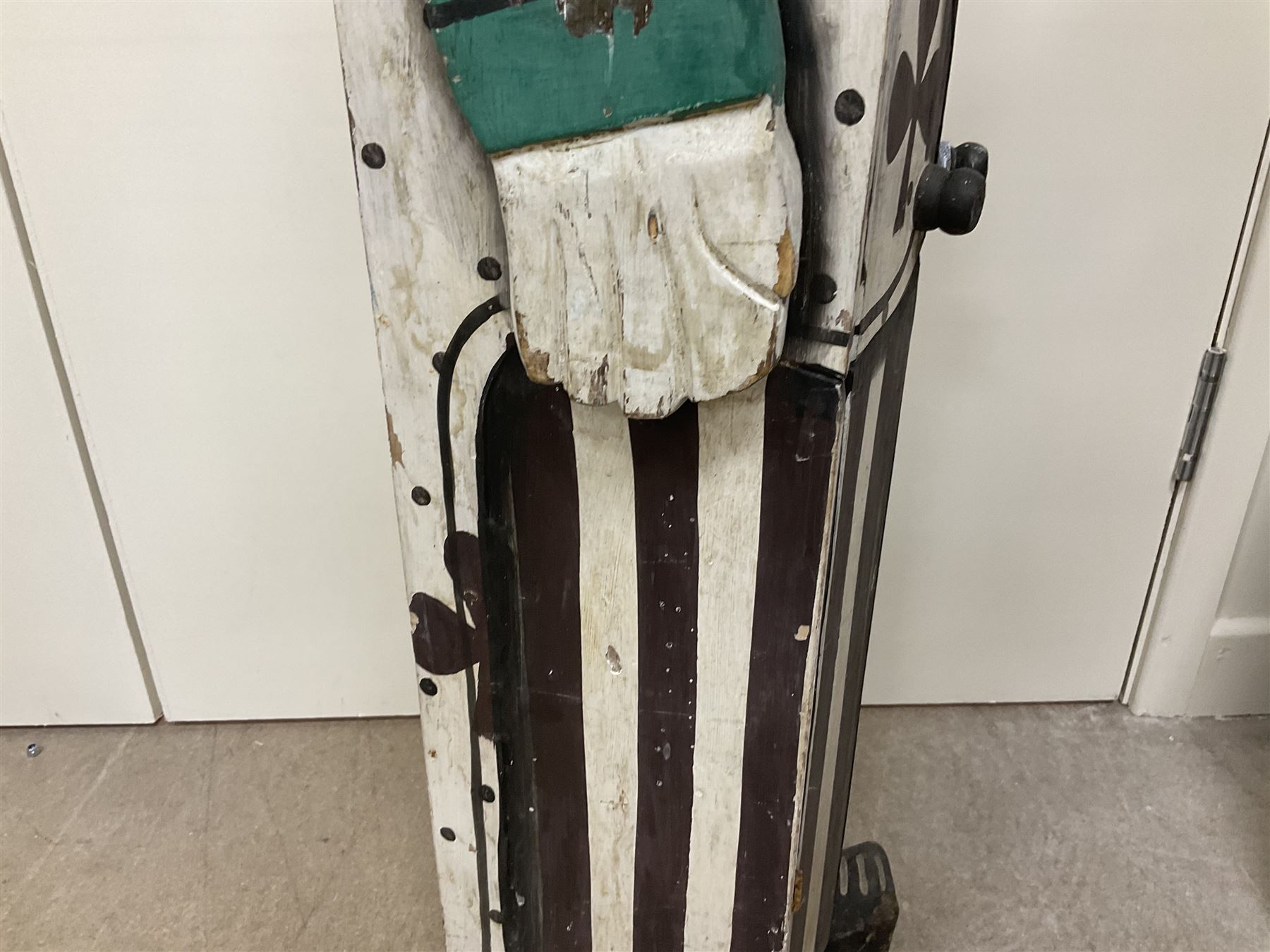 Folk art circus clown cabinet, the the two hinged doors with bow tie decoration opening to reveal fitted shelved interior, the body painted with polka dots and spades, H121cm