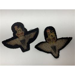 Parachute regiment - chrome crest on oak easel shield; three cloth badges; small silver plated figure; and pin badge; together with 10cm diameter cannon ball etc