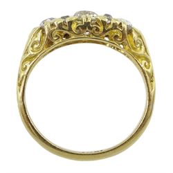 Early 20th century gold three stone old cut diamond ring, with eight diamond accents set between, stamped 18ct, central diamond approx 0.50 carat, total diamond weight approx 0.95 carat