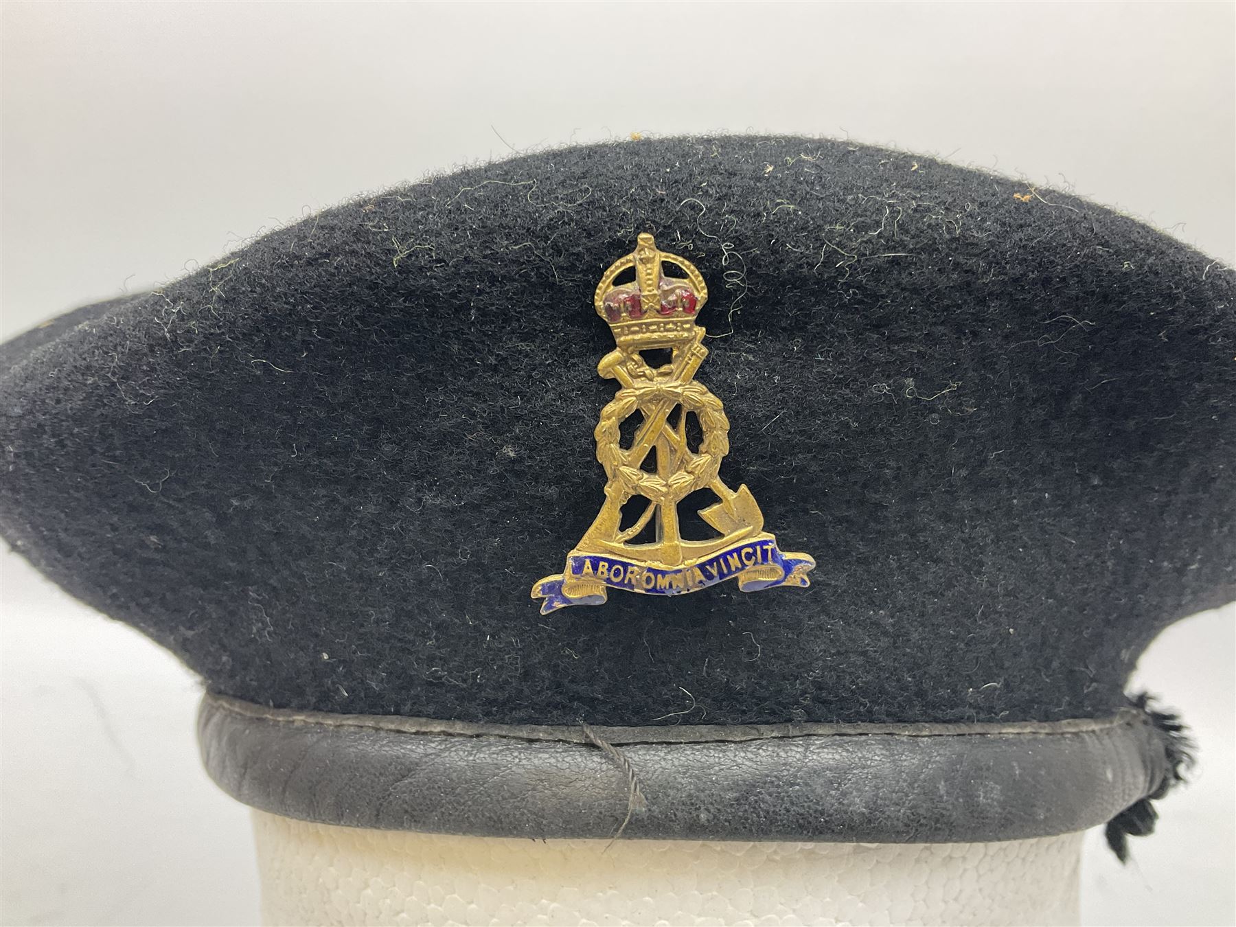 WW2 British black felt beret with Pioneer Corps cap badge, with Kangol Wear maker's mark dated 1943; and a British Army green webbing belt (2)