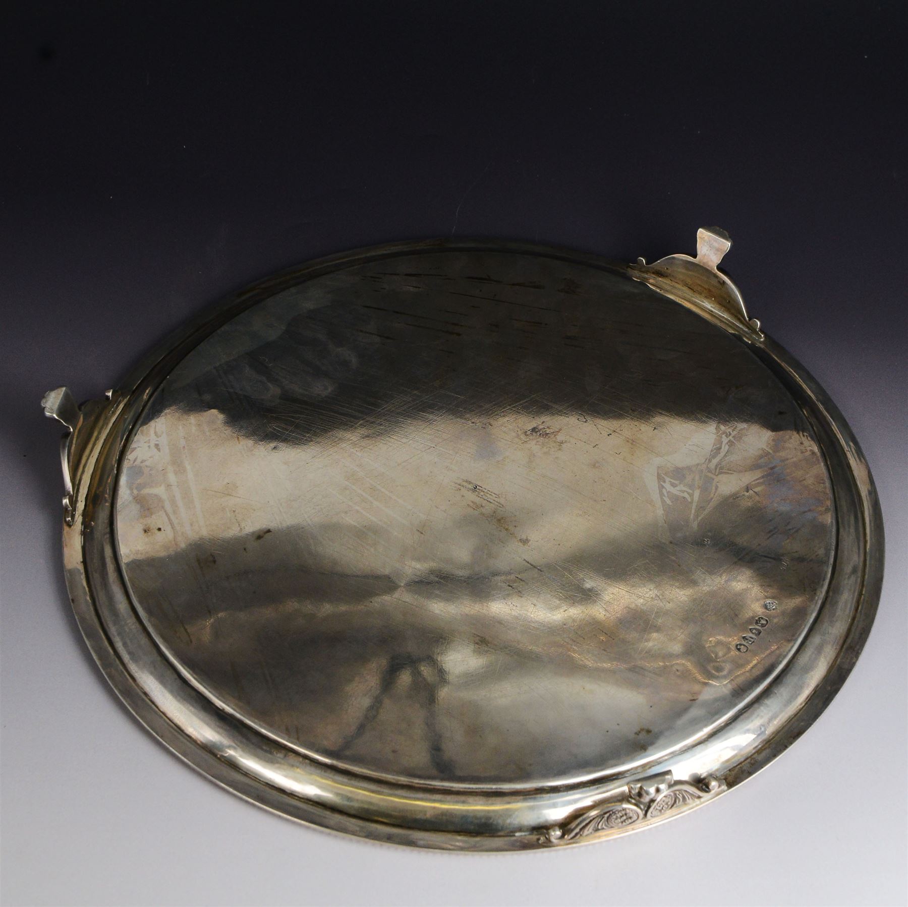 Victorian silver tray, of circular form with beaded rim, engraved to the centre with floral decoration, upon three scroll mounted paw feet, hallmarked Walter & John Barnard, London 1877, D30.5cm