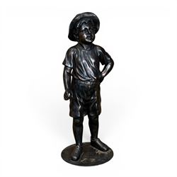 Bronzed composite figure of a boy wearing a hat, on circular plinth
