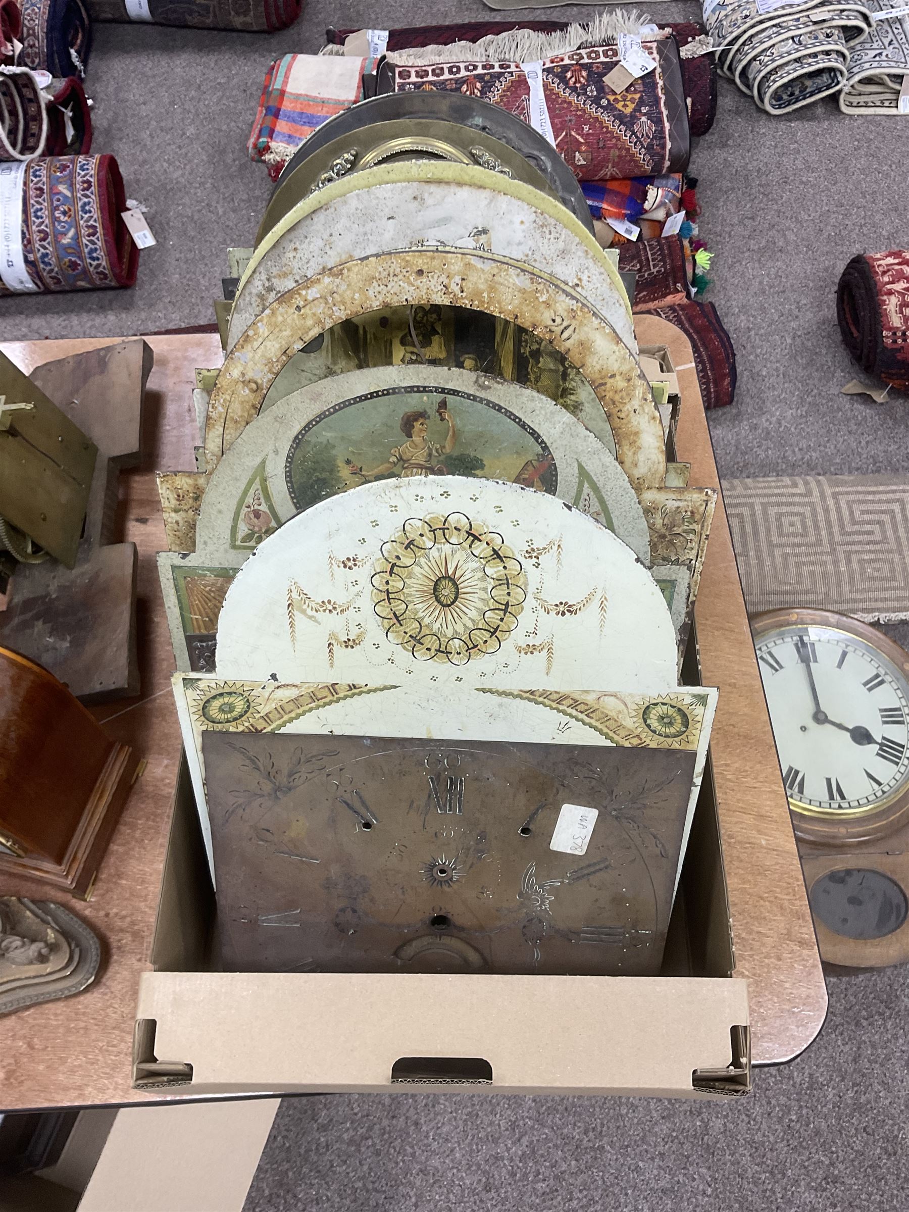 Approximately thirteen longcase clock faces, mainly 18th and 19th century, including brass and painted dials