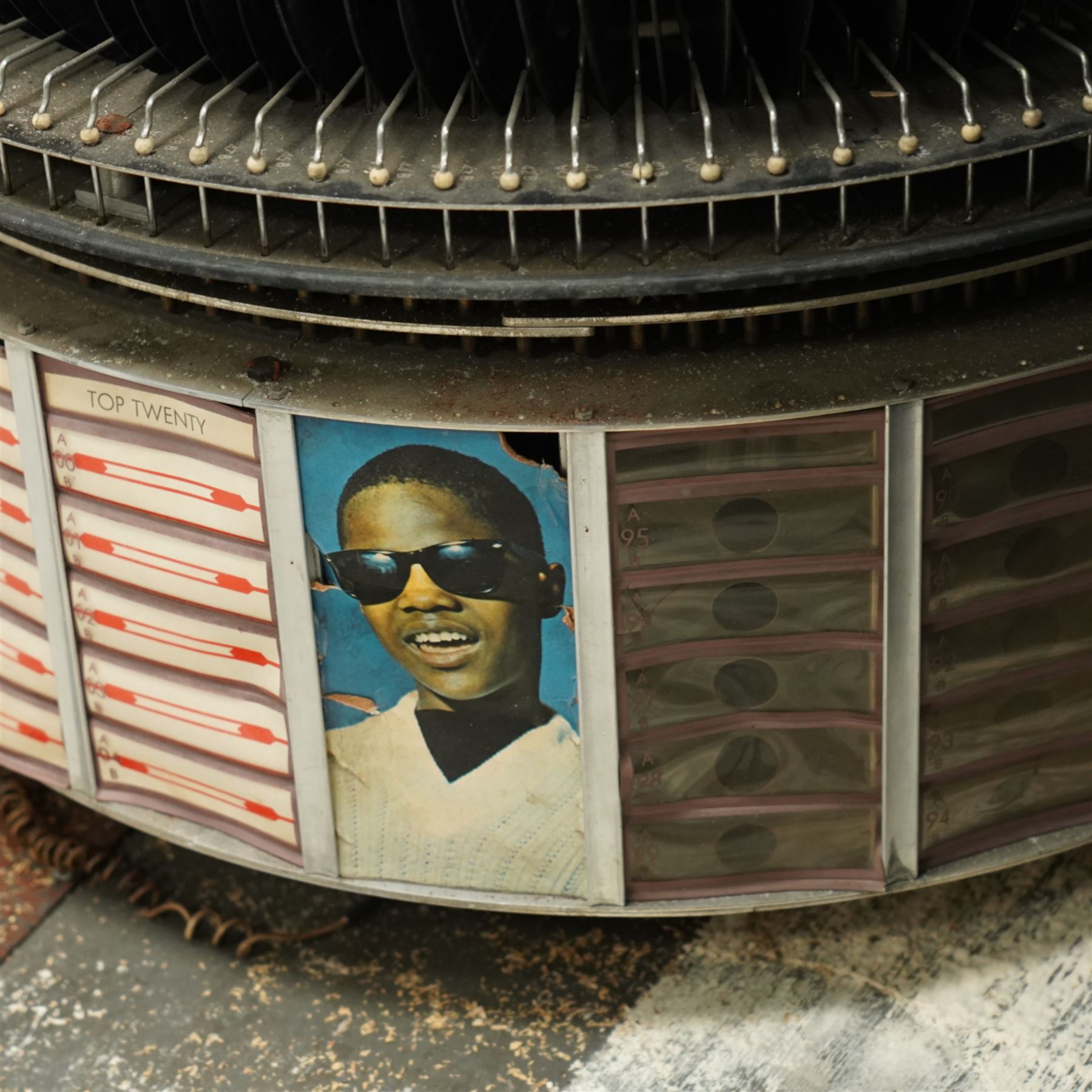 Ditchburn - 'Music Maker Panoramic 200' jukebox circa 1959, curved panoramic glazed front offering full view of the automatic selection process, accommodating 100 records (200 selections), with a stereo sound system, the aluminium trim over a woven speaker grille with an all-over ebonised and silver finish