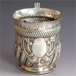 Victorian silver christening mug, of circular form with C scroll handle, embossed with scrolls and foliate decoration, with vacant oval cartouche to body, hallmarked John Aldwinckle & Thomas Slater, London 1890, contained within a tooled leather fitted case, mug H8cm