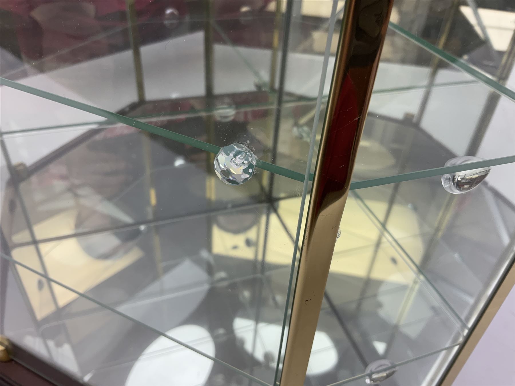 Swarovski Crystal Masquerade trilogy; 1999 Masquerade Pierrot, 2000 Columbine, 2001 Harlequin all with accompanying plaque, stand and original box, together with a glass display case with mirrored back and sides 