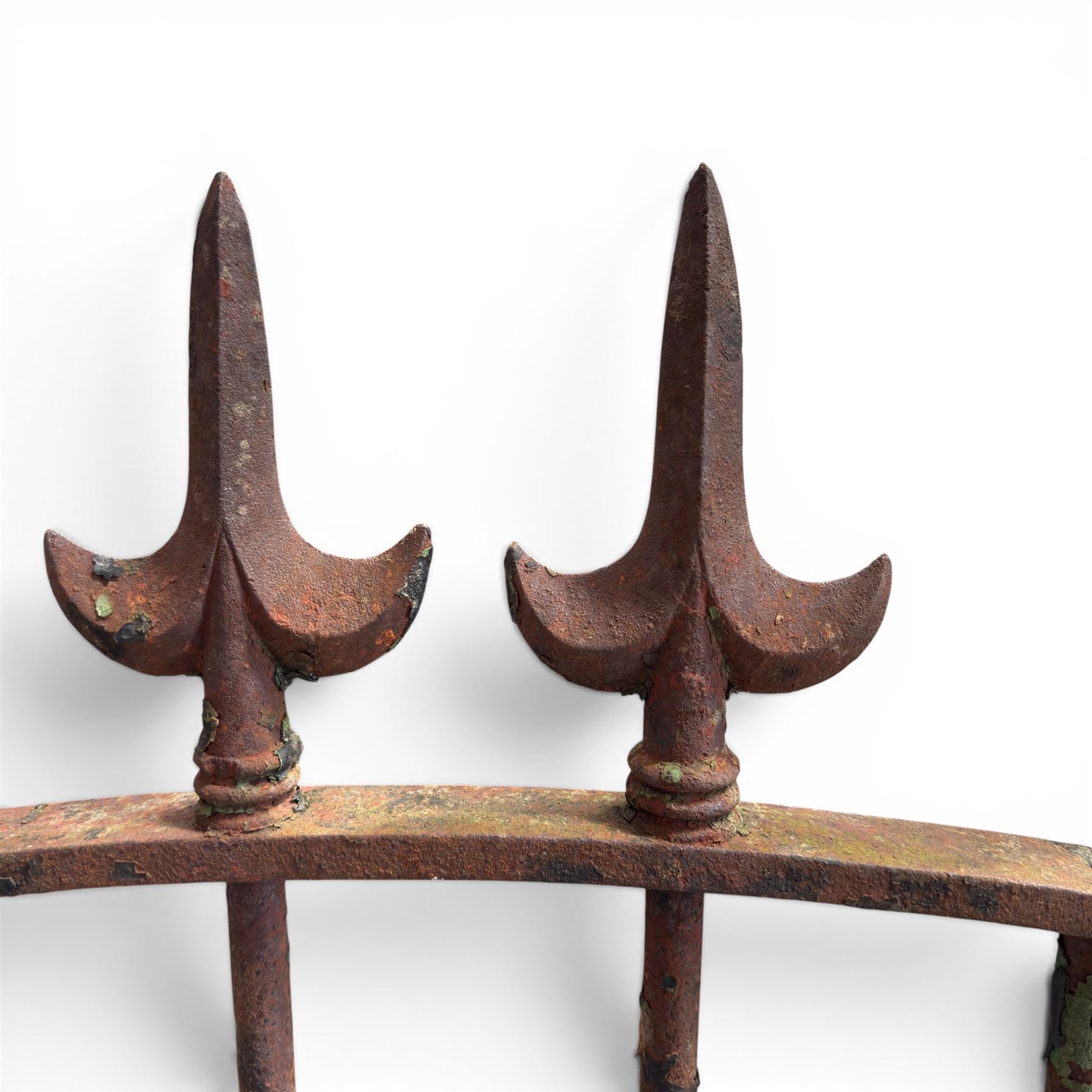 Georgian wrought iron single garden gate, pointed finial over strapwork cresting rail and arched profile with spearhead finials, the opposing side with scrollwork and hinged latch