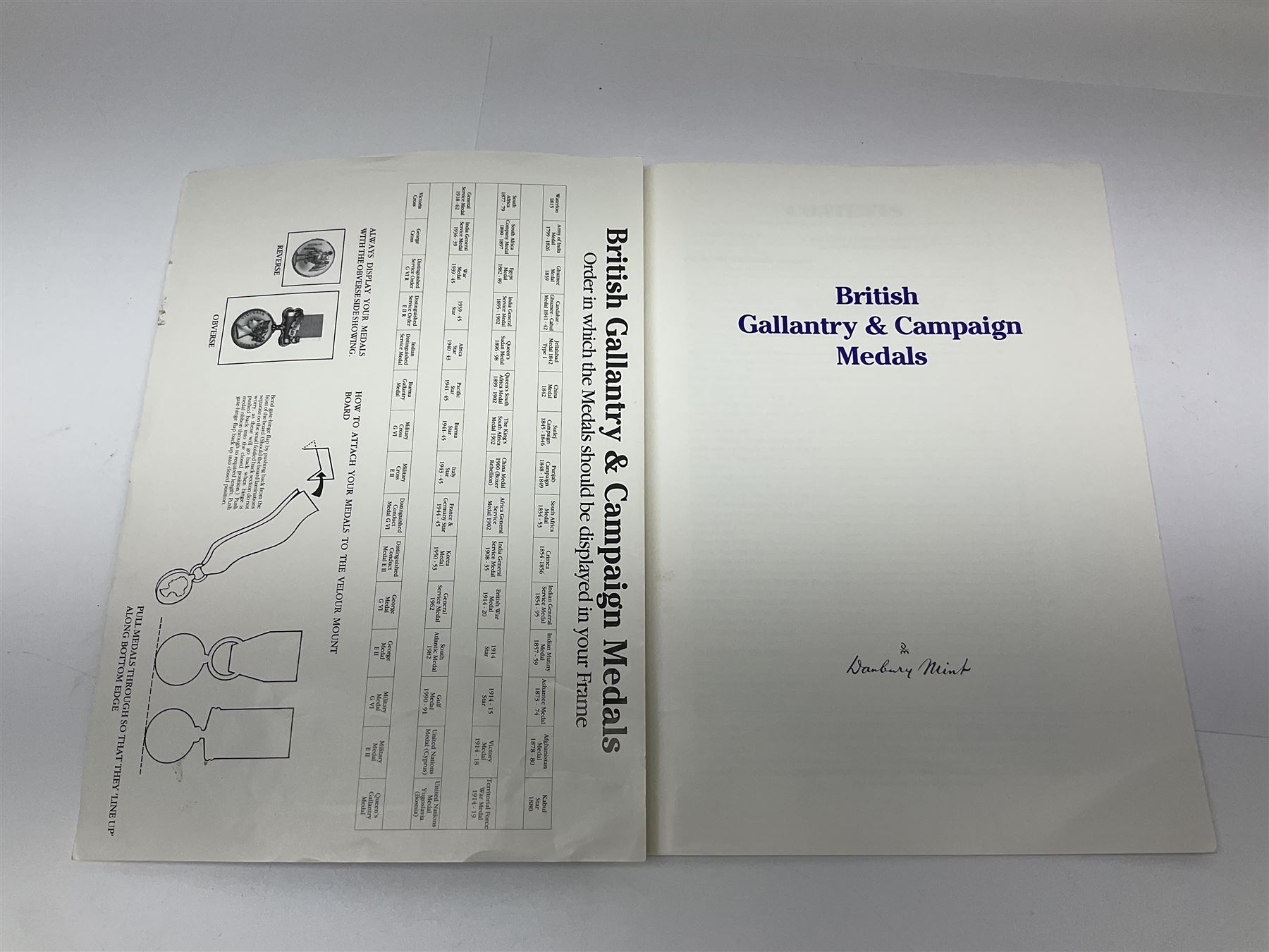 Limited edition large framed display board with sixty half-size copies of British Gallantry and Campaign Medals produced by Danbury Mint; all with ribbons and associated booklet