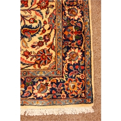  Kashan multicoloured rug, field with all over flower decoration on an ivory ground, blue repeating border, 188cm x 135cm  
